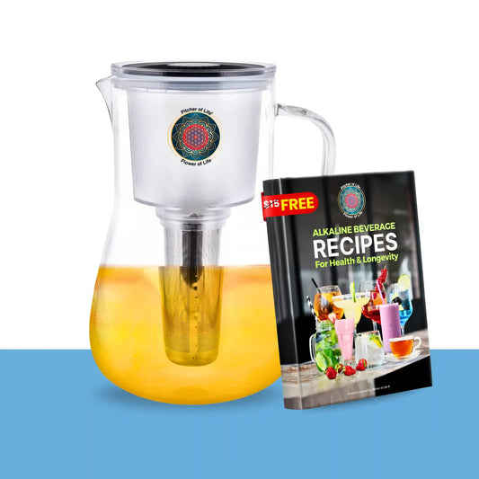 Clear pitcher with liquid and a book titled 'Alkaline Beverage Recipes' on a white background