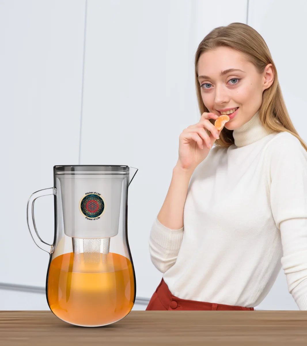 Man and woman in a kitchen with a blender and juice, holding a glass of orange juice.