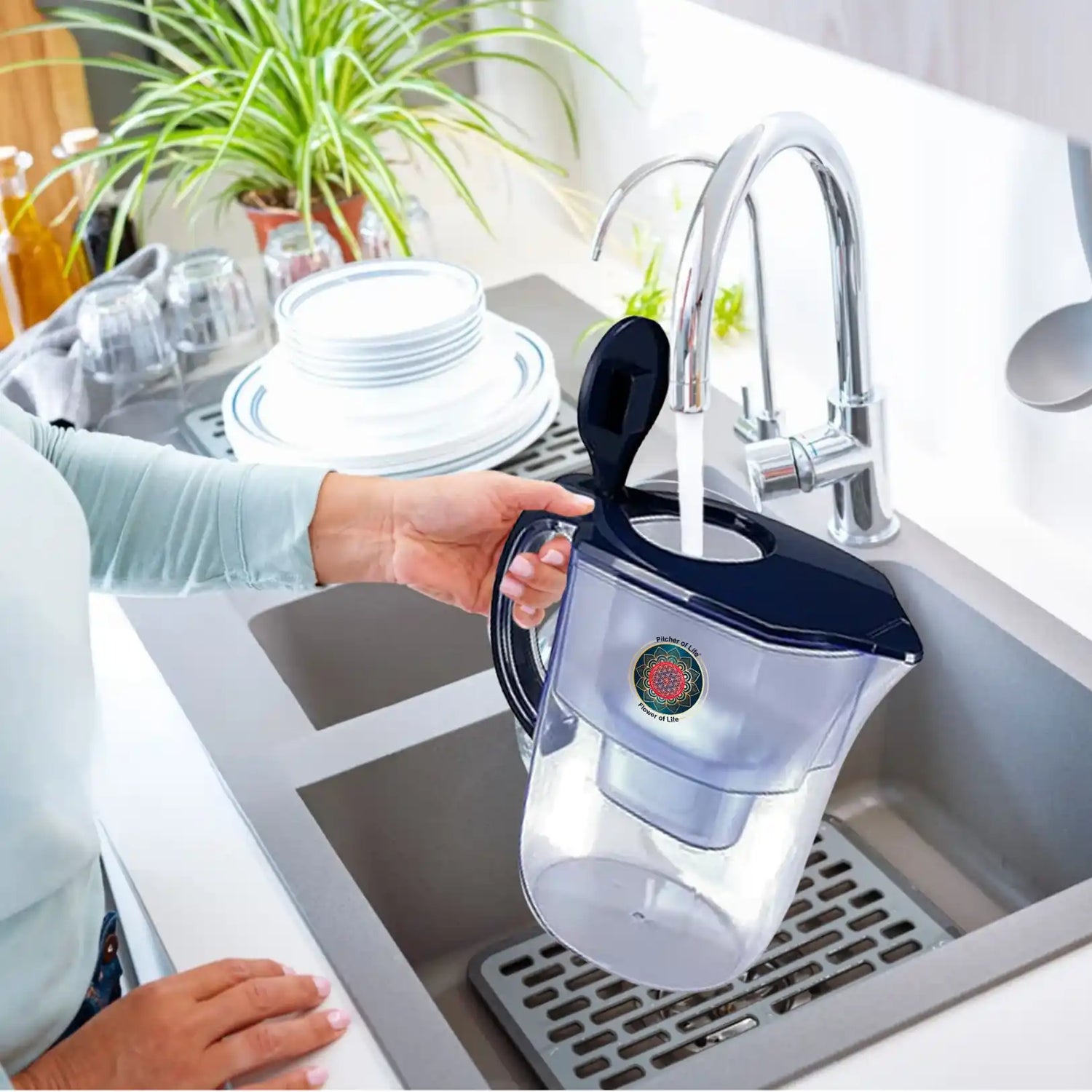 Person holding a water filter pitcher over a kitchen sink.