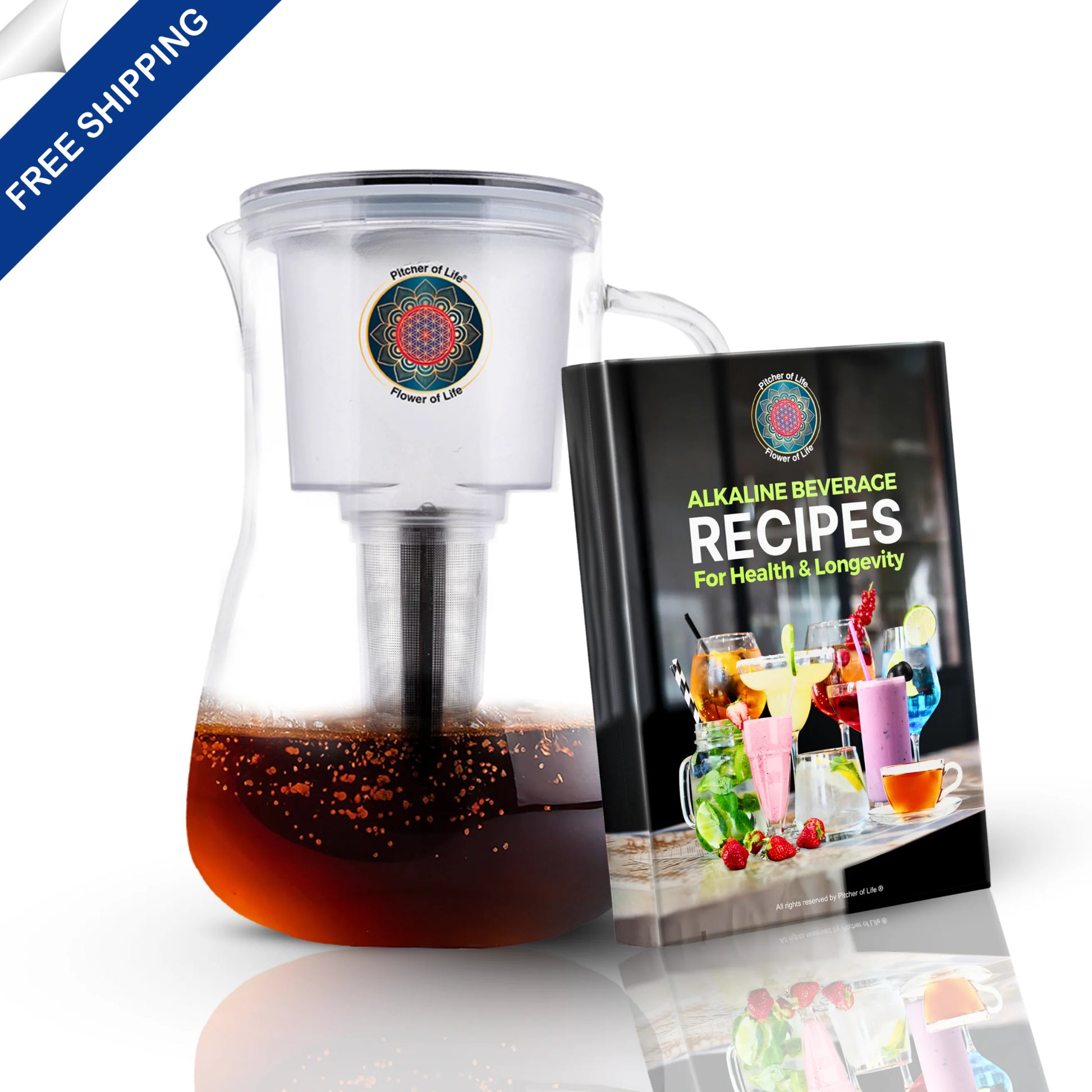 Clear pitcher with dark liquid and a book titled 'Alkaline Beverage Recipes' on a white background