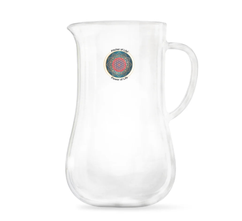 A clear glass pitcher with a curved handle and a small circular multicolor mandala design printed on the front, set against a plain white background.