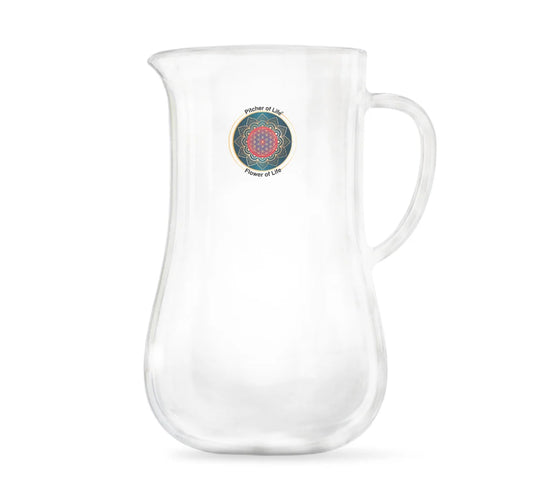 A clear glass pitcher with a curved handle and a small circular multicolor mandala design printed on the front, set against a plain white background.
